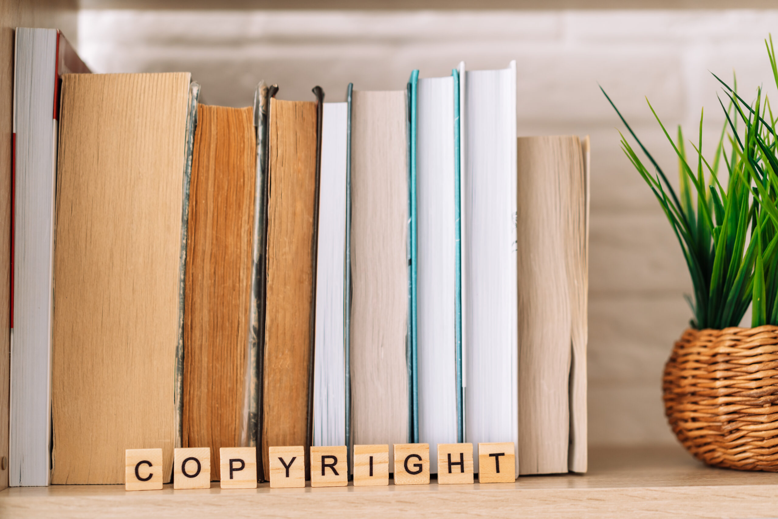 Word copyright made of letters in front of books